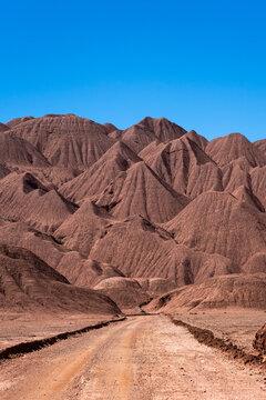 Remote dirt road winding through La Puna's rugged landscapes