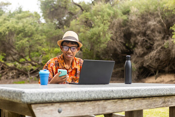Indonesian enjoying nature in Australia with technology