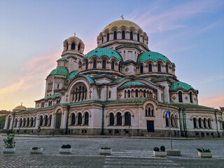 Depiction of Saint Alexander Nevsky Cathedral at sunset with a purple sky and clouds, the biggest...