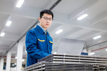 asian engineer working with laptop in factory