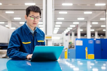 Asian engineers using laptop in factory