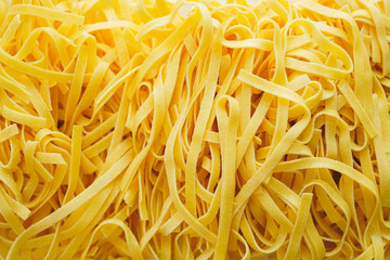 Closeup of Homemade Fresh pasta Tagliatelle, texture background 