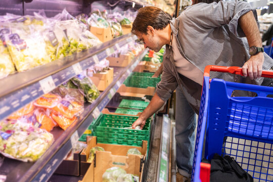 Man shopping in grocery store fresh produce section