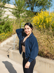 A young woman poses during a walk in the park, in a sunny morning, in Zaragoza, Spain