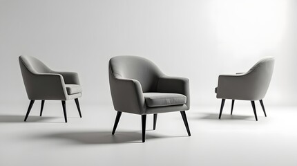 Fototapeta premium Three stylish gray armchairs with sleek legs in a minimalist setting, exuding modern elegance and comfort.