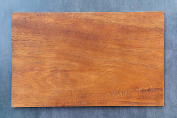 A clean wooden plaque on the table.Rectangle made of natural material on the table top view.Cherry wood.