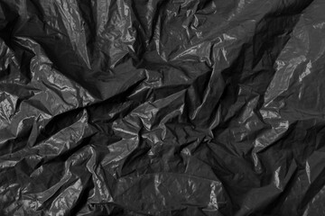 Abstract wrinkled black crumpled plastic texture background
