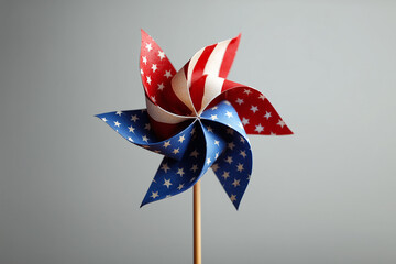 A paper pinwheel featuring the American flag design with stars and stripes. 