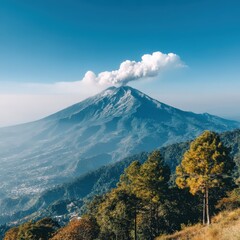 A majestic volcano gently emits a cloud of white smoke into the clear blue sky, rising above a lush green forest and distant mountains in the scenic landscape.