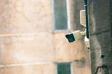 Surveillance Camera Mounted on Wall in Rainy Weather