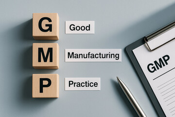 GMP: Good Manufacturing Practices Wooden Blocks with Labeled Cards, Quality Documentation and Professional Stationery in Clean Office Setting for Process Standardization..