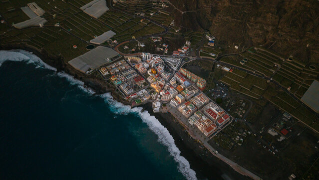Aerial view of puerto naos town with beautiful beach and coastal buildings at blue hour, La Palma Island, Canary Islands, Spain.