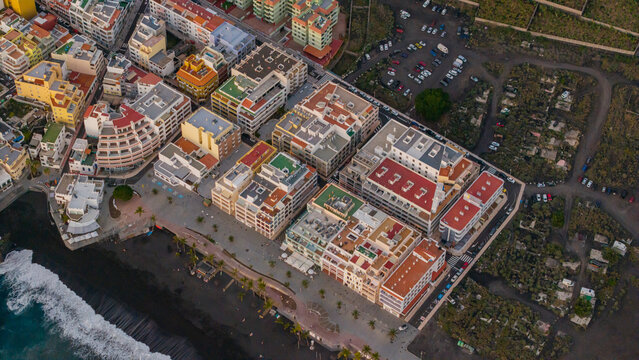 Aerial view of puerto naos town with beautiful beachfront, buildings, and palm trees, La Palma Island, Canary Islands, Spain.