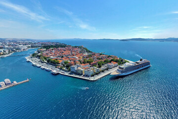 Zadar, Croatia - 05 May 2023: Aerial view of MV Viking Sea docked in a beautiful bay with a picturesque old town and coastal landscape, Zadar, Croatia.