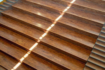 Wooden stadium, stepped seating area with staircase integrated into the seating area in a modern...