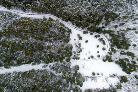 Aerial view of former Olympic bobsleigh track surrounded by snowy forest and trees, Sarajevo, Bosnia and Herzegovina.