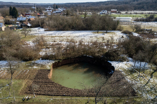 Aerial view of sinkholes in a rural landscape one year after a 6.3-magnitude earthquake, Mececani, Croatia.