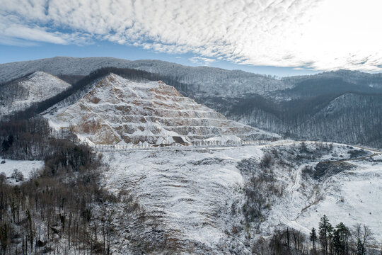 Aerial view of a landslide on state road D 74 surrounded by serene winter landscape and majestic mountains, Krapina, Croatia.