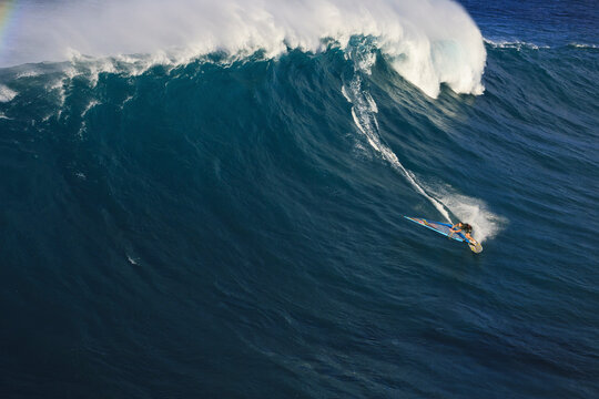 Ile De Maui, United States - 23 November 2007: Aerial view of surfers riding majestic ocean waves in vibrant blue waters, Ile De Maui, Hawaii, United States.