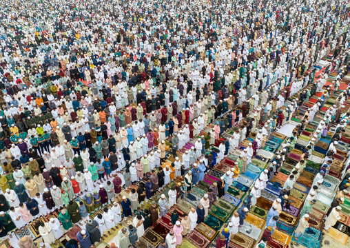 Aerial view of the sacred gathering of devotees during Eid al-Fitr with colorful prayer mats, Sher-e-Bangla Nagar, Dhaka, Bangladesh.