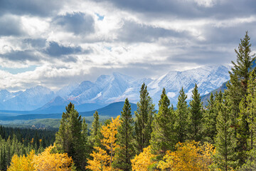 Canadian Rockies landscape near Canmore, Alberta, featuring snow-dusted mountain peaks overlooking...