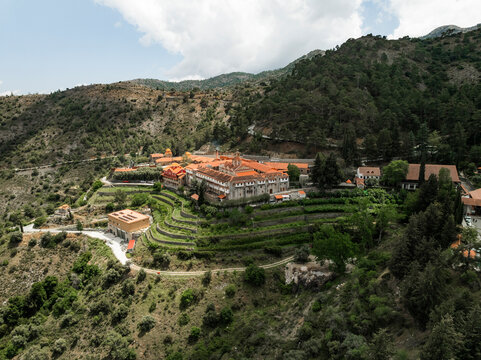 Aerial view of the holy monastery of Panagia Machaira surrounded by serene mountains and lush greenery, Troodos Mountains, Lazanias, Nicosia, Cyprus.