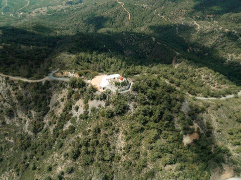Aerial view of serene Troodos Mountains with lush greenery and a remote village, Vavatsinia, Larnaca, Cyprus.