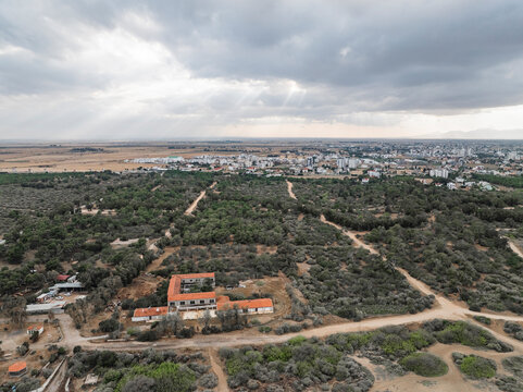 Aerial view of ancient Salamis with historical ruins, buildings, and greenery under a cloudy sky, Agios Sergios, Famagusta, Turkish Republic of Northern Cyprus.