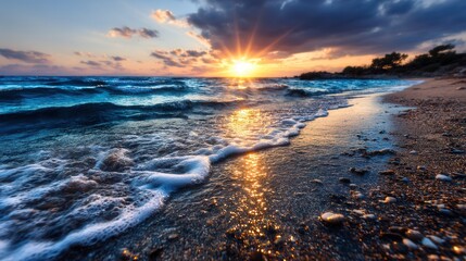 Fototapeta premium Dramatic sunset over the ocean, waves gently crashing on the beach