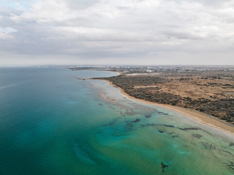 Aerial view of the serene coastline and beautiful beach of Ancient Salamis, Agios Sergios, Famagusta, Turkish Republic of Northern Cyprus.