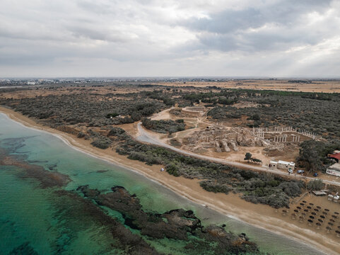 Aerial view of ancient ruins along a beautiful coastline with sandy beach and clear sea, Agios Sergios, Famagusta, Turkish Republic of Northern Cyprus.