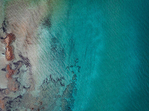 Aerial view of beautiful turquoise beach and coast with clear ocean water, Agios Sergios, Famagusta, Turkish Republic of Northern Cyprus.