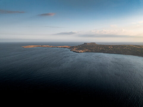 Aerial view of beautiful coastline at sunset with tranquil ocean and distant horizon, Cyclops Cave, Paralimni, Famagusta, Cyprus.