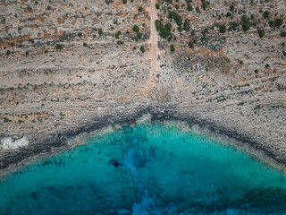 Aerial view of beautiful rocky coastline with crystal clear turquoise water and scenic cliffs, Cyclops Cave, Paralimni, Famagusta, Cyprus.