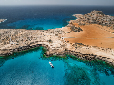 Aerial view of beautiful blue lagoon with serene turquoise waters and picturesque coastline, Cape Greco Peninsula, Agia Napa, Famagusta, Cyprus.