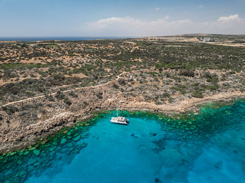 Aerial view of blue lagoon with turquoise water and rocky shore, Cape Greco Peninsula, Agia Napa, Famagusta, Cyprus.