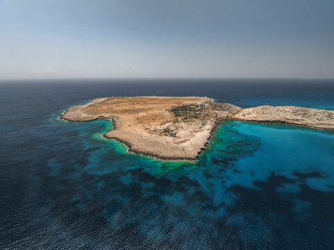 Aerial view of blue lagoon with turquoise water and rocky shore, Cape Greco Peninsula, Agia Napa, Famagusta, Cyprus.