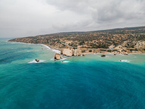 Aerial view of beautiful Aphrodite Beach with serene rock formations and azure sea, Kouklia, Paphos, Cyprus.