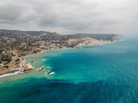 Aerial view of beautiful Aphrodite Beach with rocky cliffs and azure sea, Kouklia, Paphos, Cyprus.