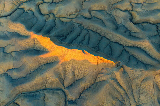 Aerial view of rugged canyon landscape with dry desert terrain and beautiful natural formations, Hanksville, Utah, United States.