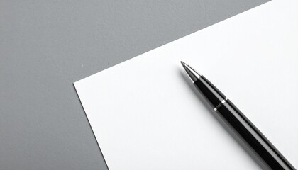 Close up photo of a pen on a blank white paper on a table