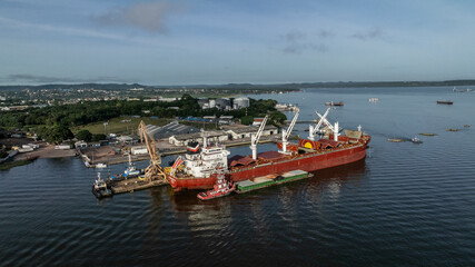 Santarem, Brazil - 08 May 2023: Aerial view of cargo ships and cranes at a bustling port along the river, Santarem, Para, Brazil.