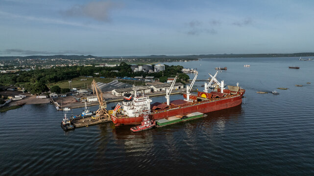Santarem, Brazil - 08 May 2023: Aerial view of cargo ships and cranes at a bustling port along the river, Santarem, Para, Brazil.