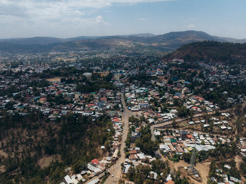 Aerial view of a beautiful cityscape with buildings amidst hills and roads, Debre Birhan, Amhara, Ethiopia.