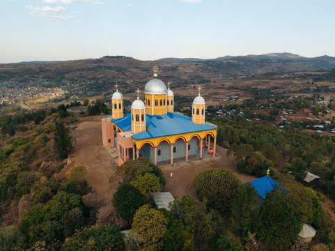 Aerial view of keranyo medhanyalem orthodox church surrounded by scenic hills and trees, Maraki, Amhara, Ethiopia.