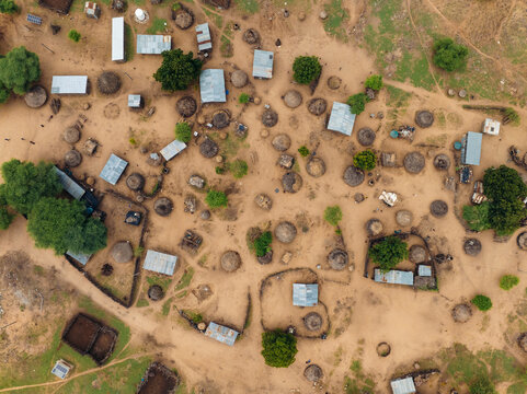 Aerial view of traditional huts and dirt paths in a Karo Tribe village surrounded by trees, Korcho, Southern Nations Nationalities and Peoples' Region, Ethiopia.