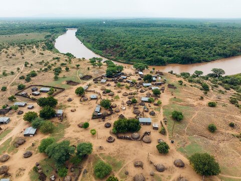 Aerial view of traditional Karo Tribe village surrounded by lush greenery and a winding river, Korcho, Southern Nations Nationalities and Peoples' Region, Ethiopia.