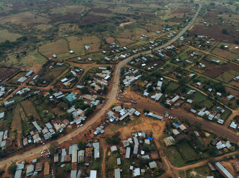 Aerial view of a beautiful rural village with houses, roads, and fields surrounded by nature, Kako, Southern Nations Nationalities and Peoples' Region, Ethiopia.