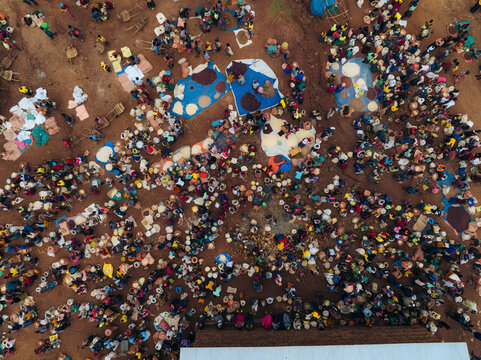 Aerial view of a bustling tribal market filled with colorful stalls and a diverse crowd, Kako, Southern Nations Nationalities and Peoples' Region, Ethiopia.