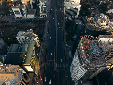 Aerial view of vibrant downtown cityscape with modern high-rise buildings and busy traffic at sunset, Bole, Addis Ababa, Ethiopia.